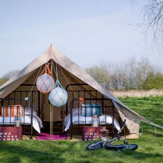 outdoor bedroom with buoy lights and tent