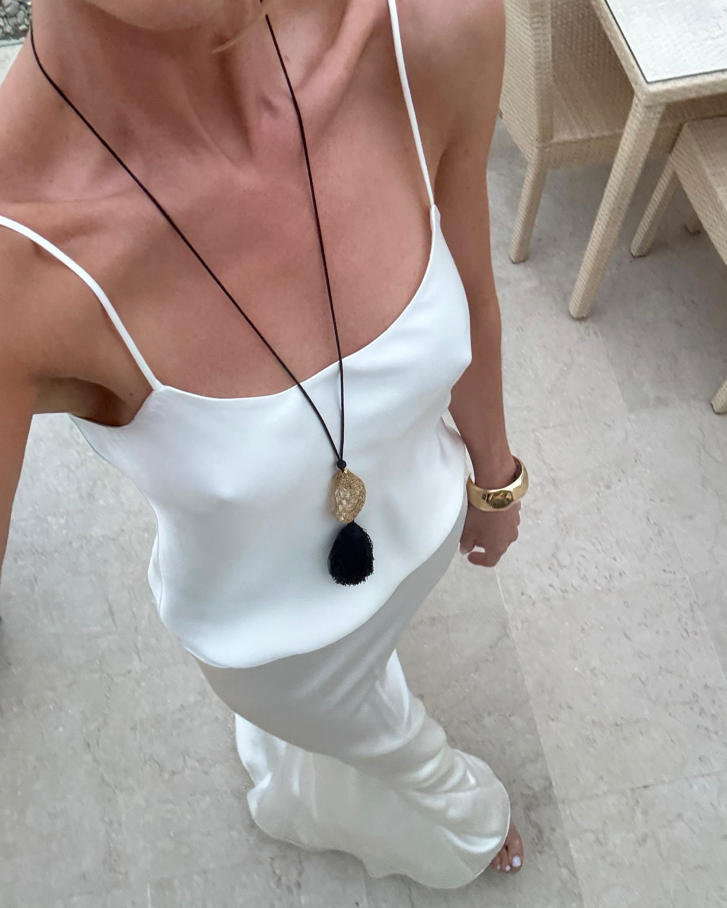 An image of Rosie Huntington-Whiteley wearing one of the best statement necklaces with a white dress.