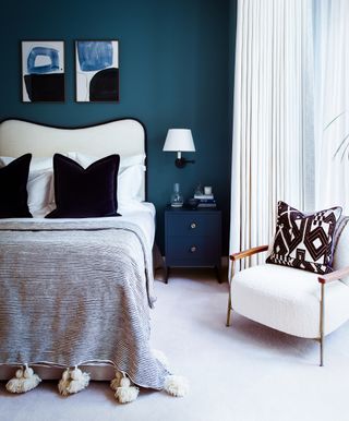 A blue themed bedroom with a dark blue accent wall
