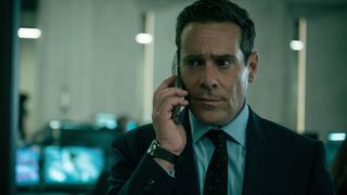 James Callis holds up a phone to his ear in Slow Horses season 5