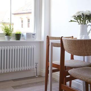 Dining room with white radiator and wooden dining room table with accessories