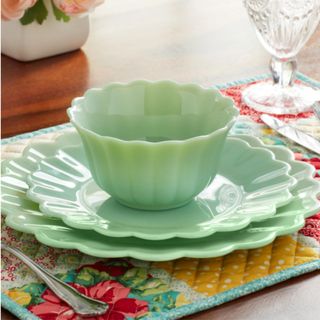 A green dining set with two plates and a bowl