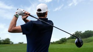 A golfer hits a drive with the Huawei watch on their wrist