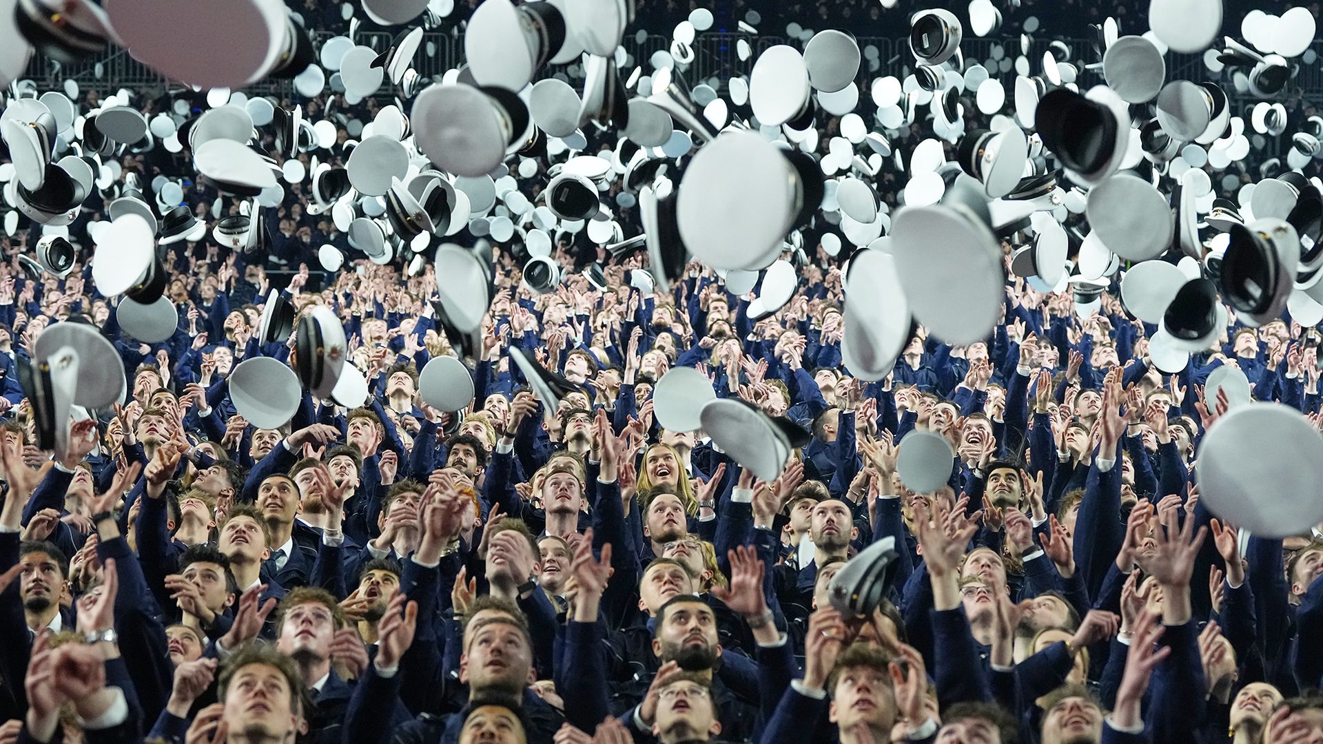 
                                Police officer graduates throw their hats in the air after taking oaths of service in Cologne, Germany
                            
