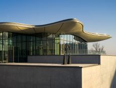 exterior with glass top and wavy roof at Stiftung Froehlich in Stuttgart by Gabriele Glöckler