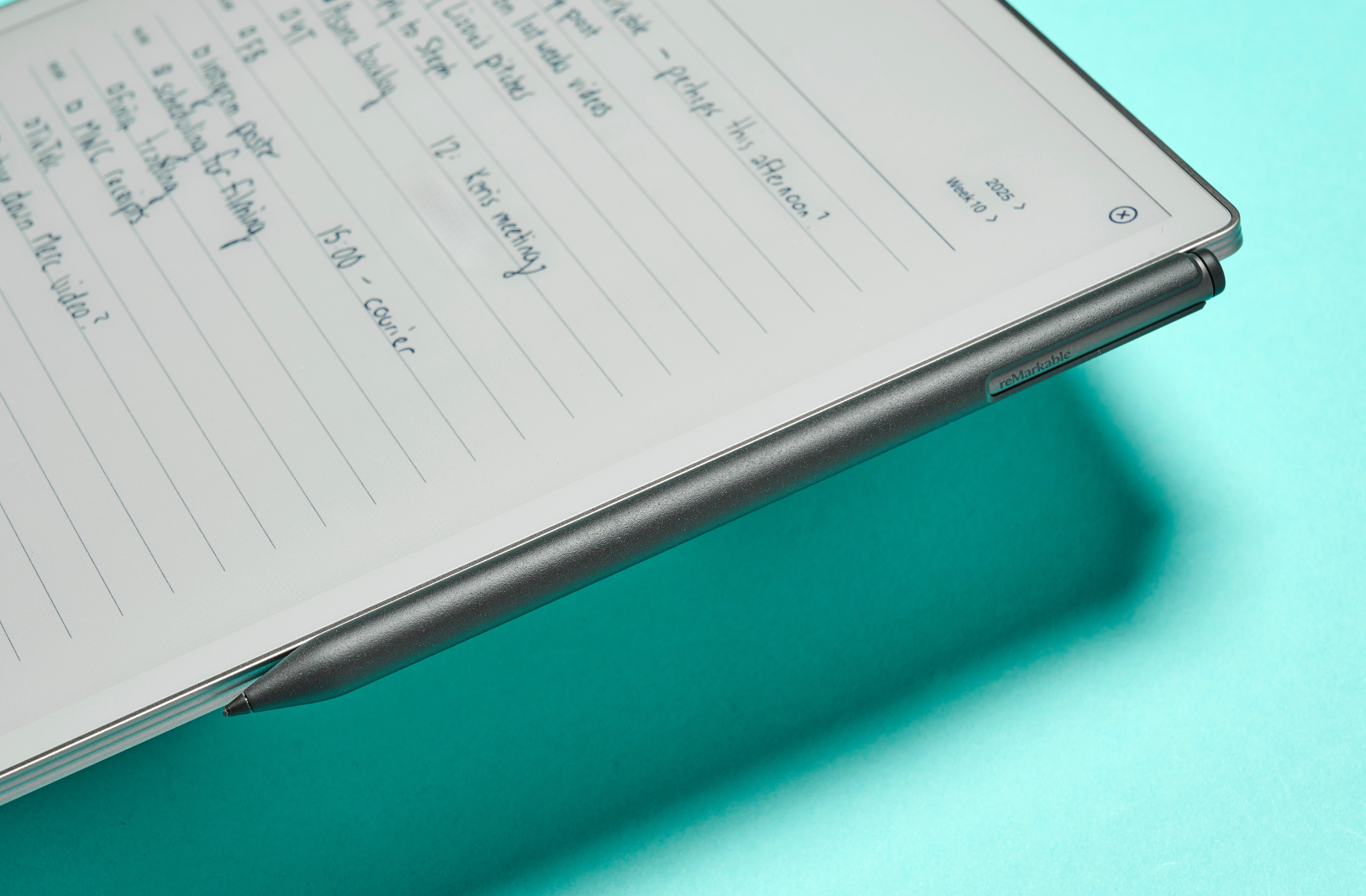 The reMarkable Paper Pro up close from the side, showing the Marker Plus attached to the magnetic charging dock
