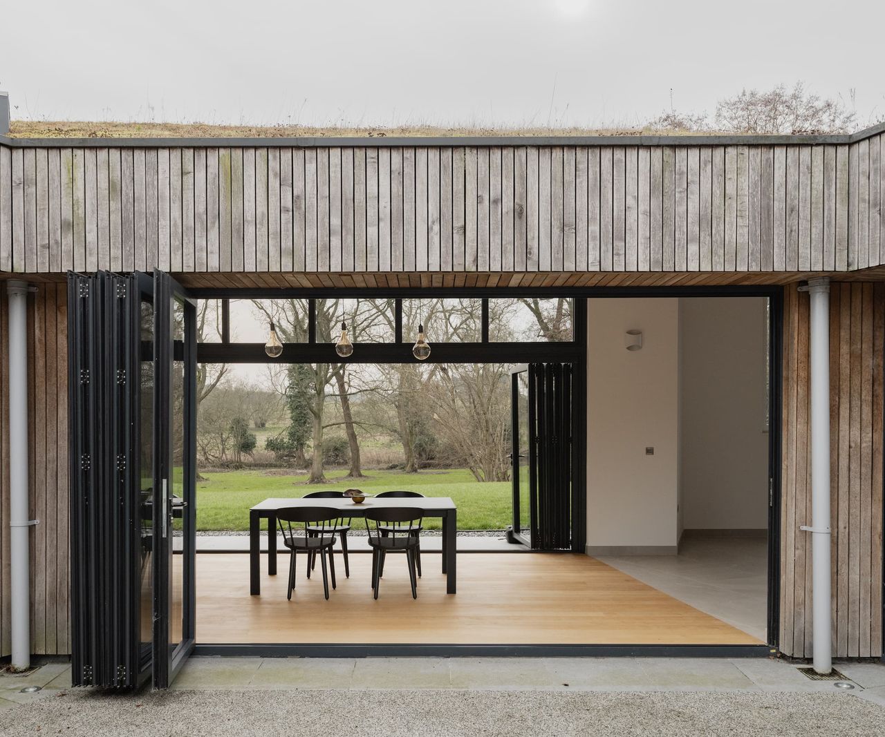 A walkthrough living room from both sides of a timber clad house