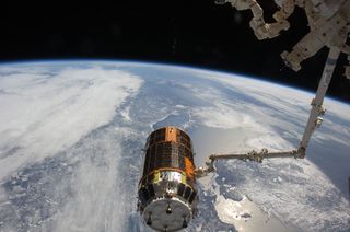 The Canadarm2 robotic arm attached to the International Space Station prepares to release the Japanese cargo ship Kounotori2 (