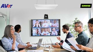 AVer and Shure have teamed up for AI voice-tracking shown here in a small conference room with happy people conducting a video call. 