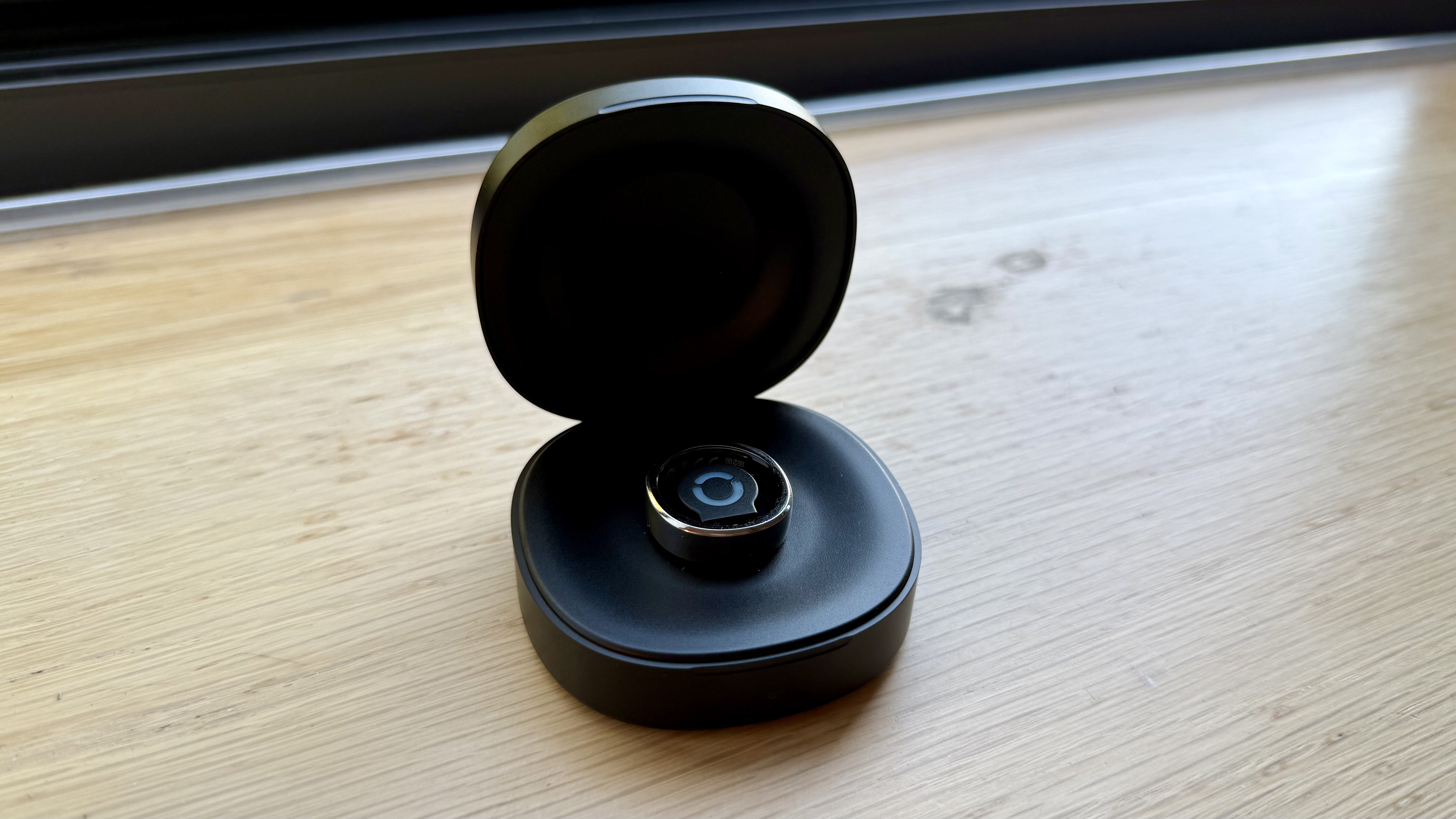 The RingConn Gen 3 in silver pictured in its charging case