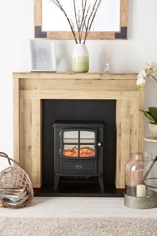 Scandi fireplace surround with electric stove in living room