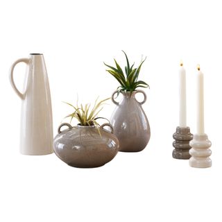 A ceramic accessory set with vases and candle holders in neutral colors