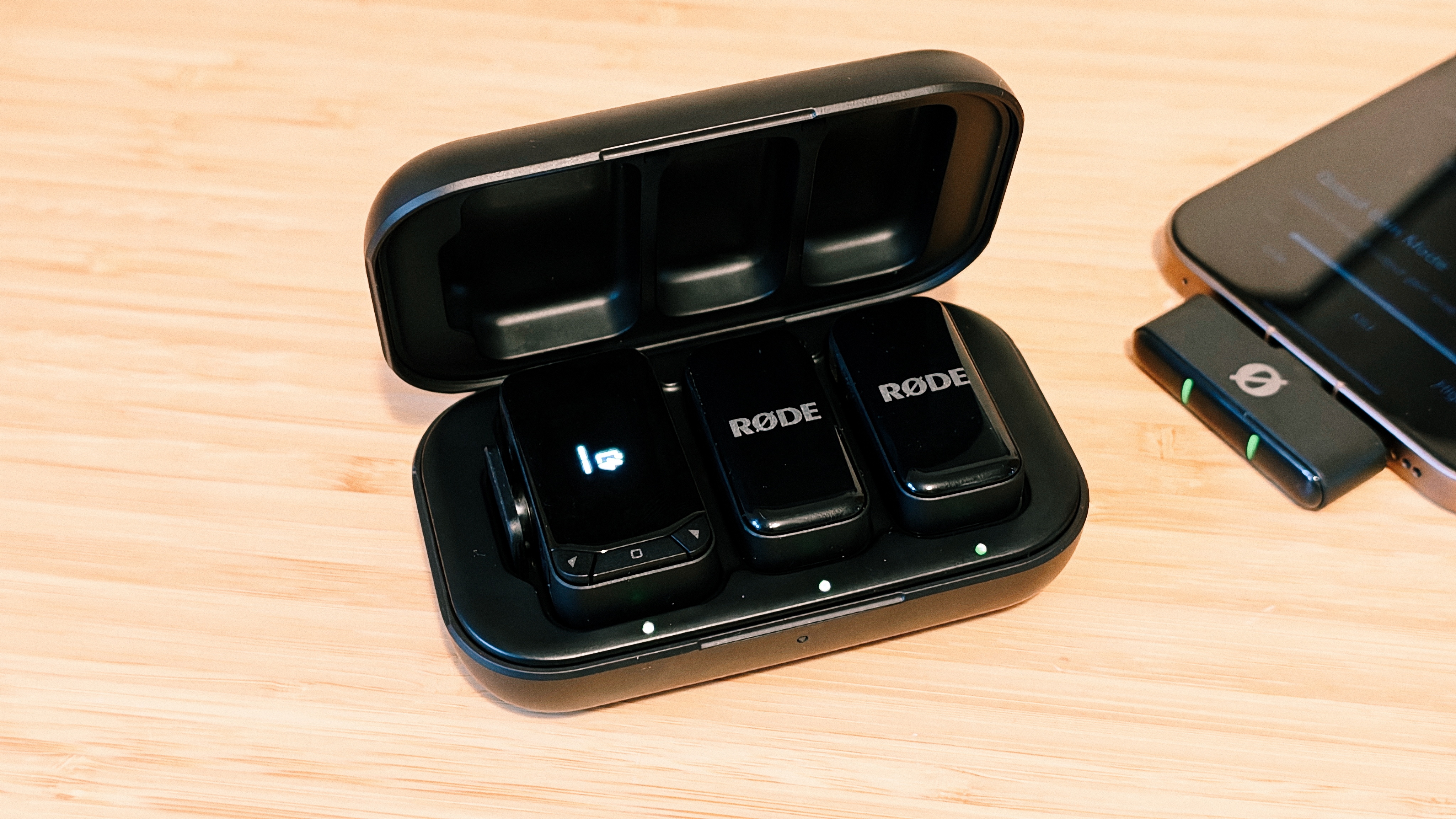 A Rode Wireless Micro Camera Kit on a wooden desk