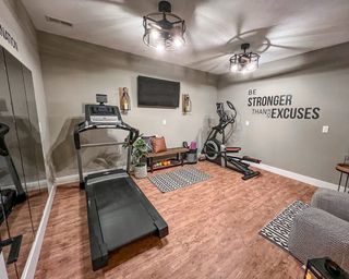 home gym with bright lighting, weights, gym equipment and mirror wall - Funcy Decor