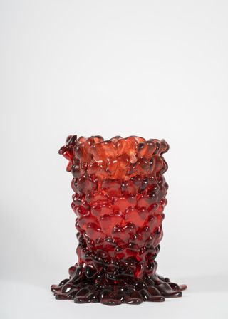Handcrafted vessel made from red melted glass.