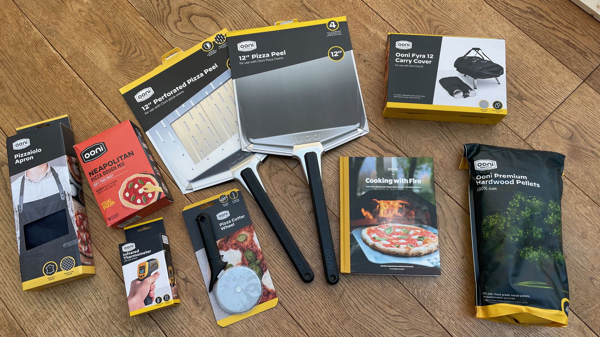 Ooni Fyra 12 accessories - a pizza peel, pellets, and recipe books
