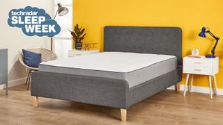 Nectar Memory Foam Mattress on a grey fabric bed base placed against a bright yellow wall