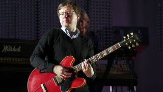 Mark Webber of Pulp performs on stage with a red Gibson ES-335 during day three of Leeds Festival at Bramham Park on August 28, 2011 in Leeds, United Kingdom