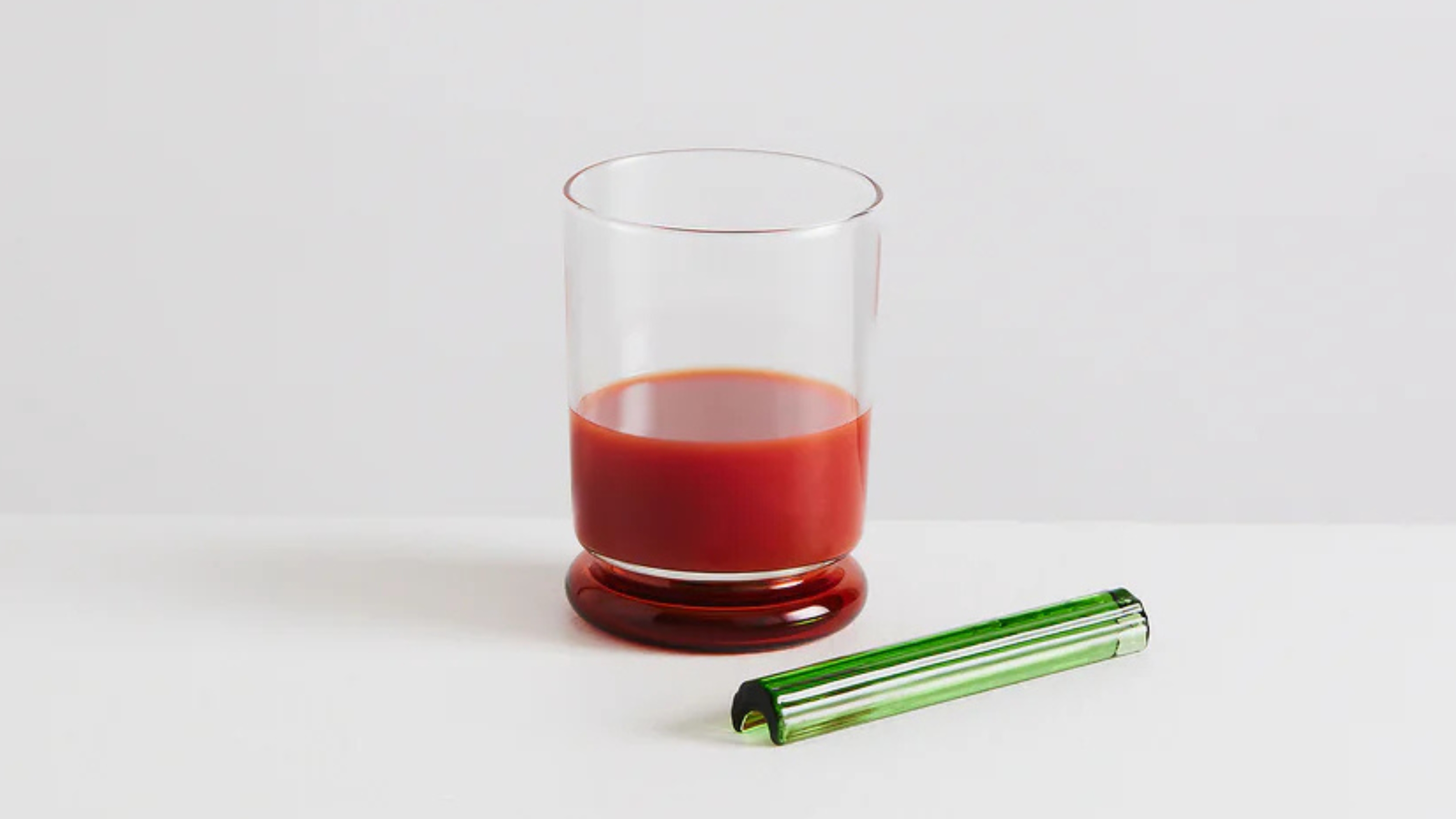 a bloody mary glass with a glass celery stick