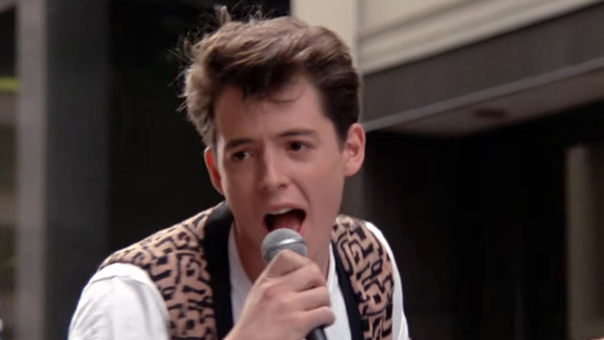 Matthew Broderick sining in to a microphone in Ferris Bueller's Day Off