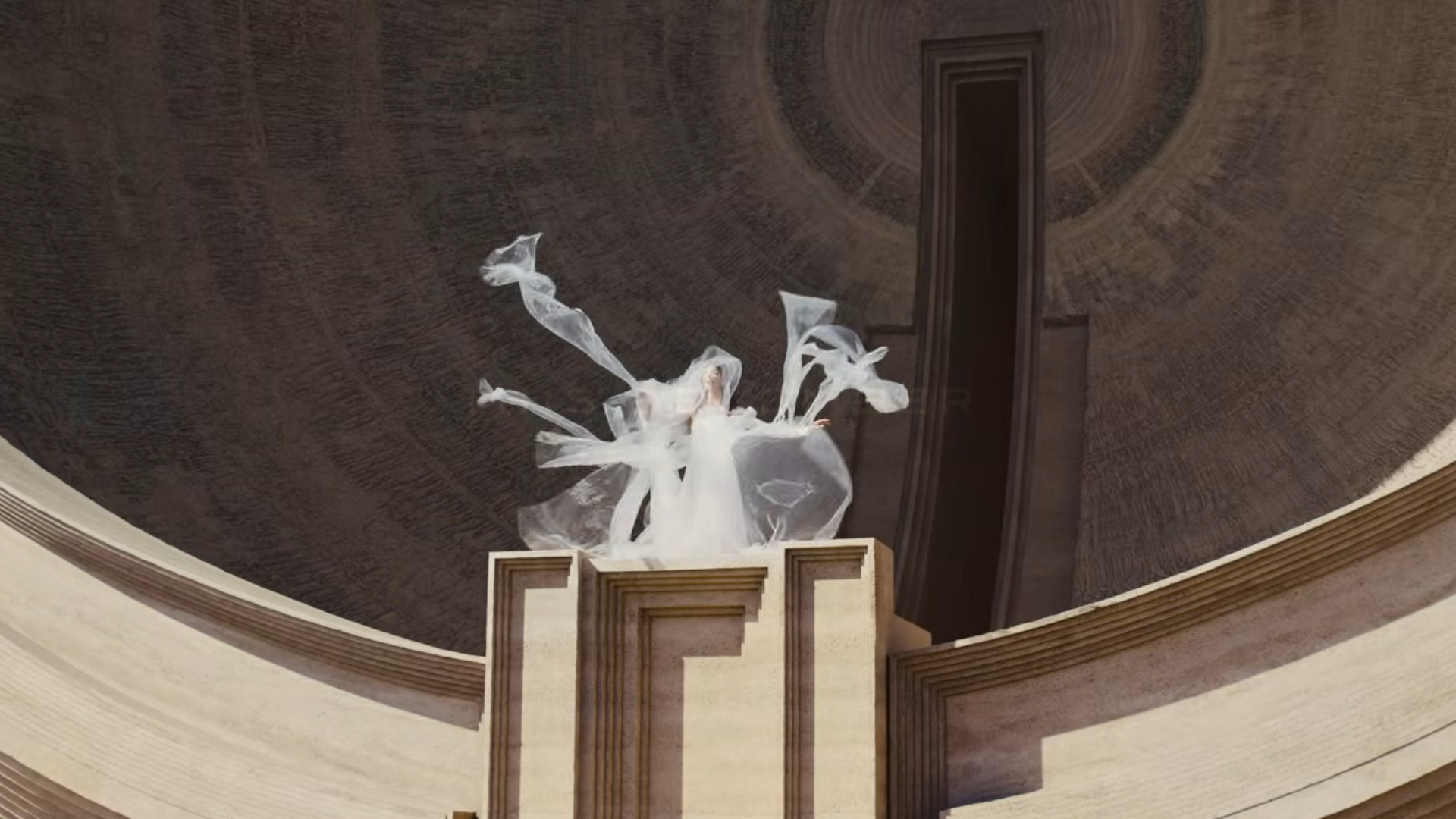 A woman wearing white standing on a futuristic building during the trailer for Dune: Part 3.