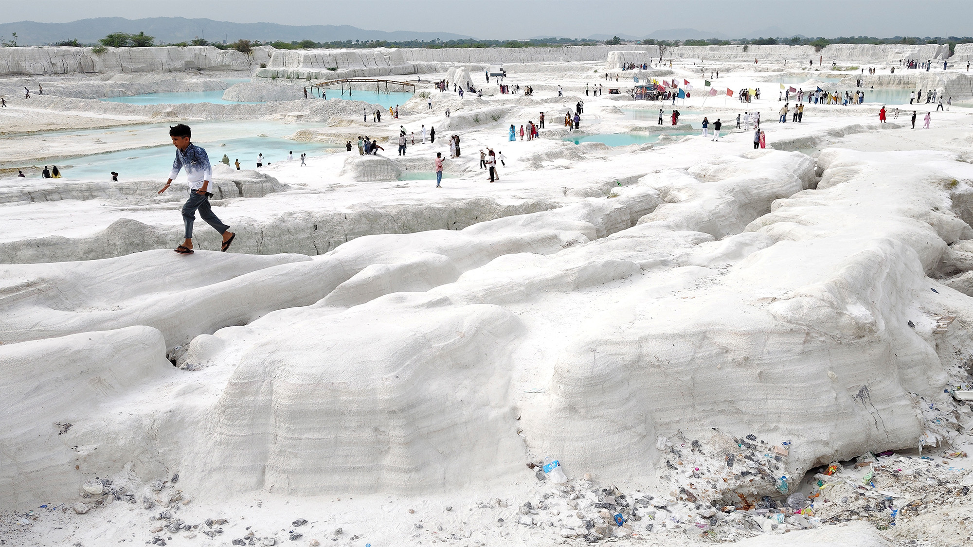 A young boy walks atop mounds of snow white marble dust at a marble-waste dumping yard, which has become an unlikely tourist attraction in Kishangarh, India