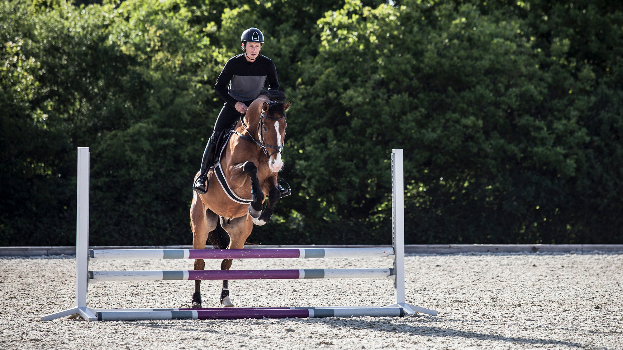 Scott Brash jumping small upright fence towards camera