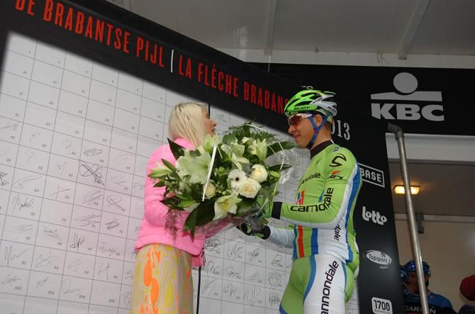 Peter Sagan (Cannondale) presents flowers to say he's sorry for pinching this podium girl's behind