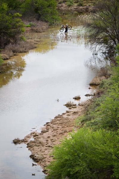 A rider crosses a river during stage 2