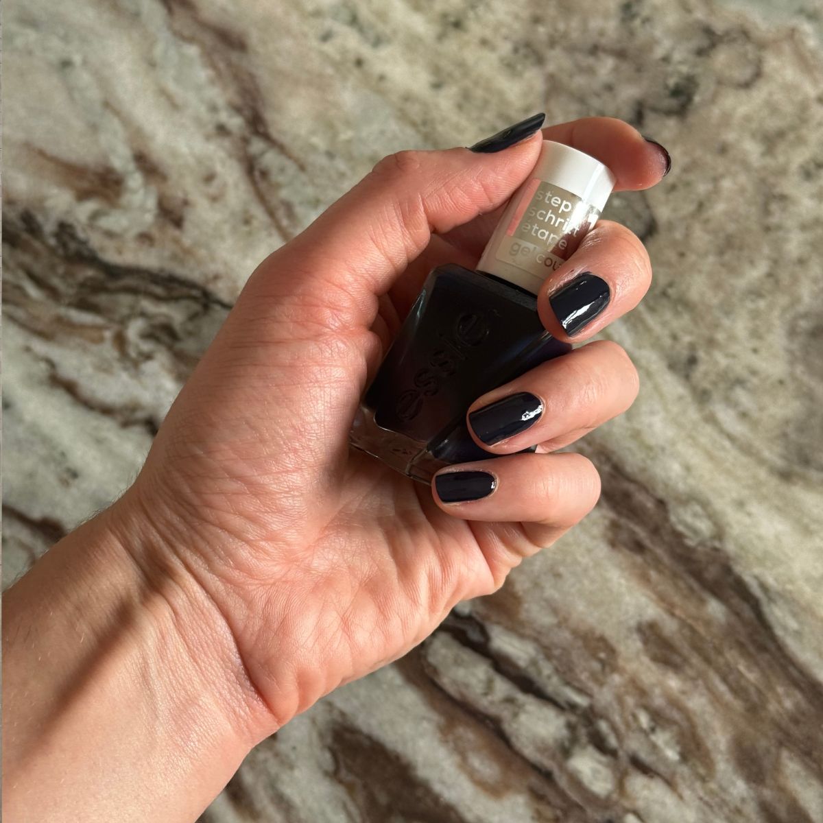 Eleanor holding a bottle of nail polish