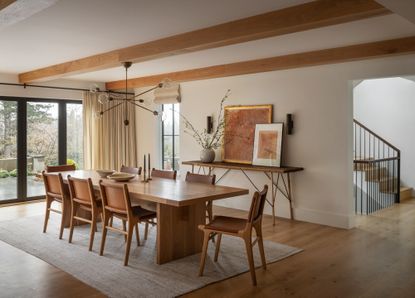 a modern dining room with beige window treatments