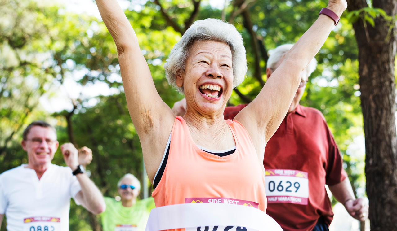 Senior woman finishing a half-marathon