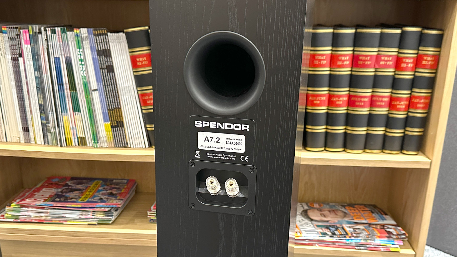 Spendor A7.2 floorstanding speaker in front of bookcase, rear of cabinet showing port and binding posts