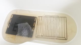 Oven trays soaking in the bath