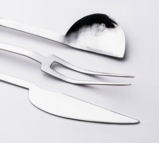 A close-up of Nina Gonzalez Cutlery featuring a two-pronged fork, a knife and a spoon.