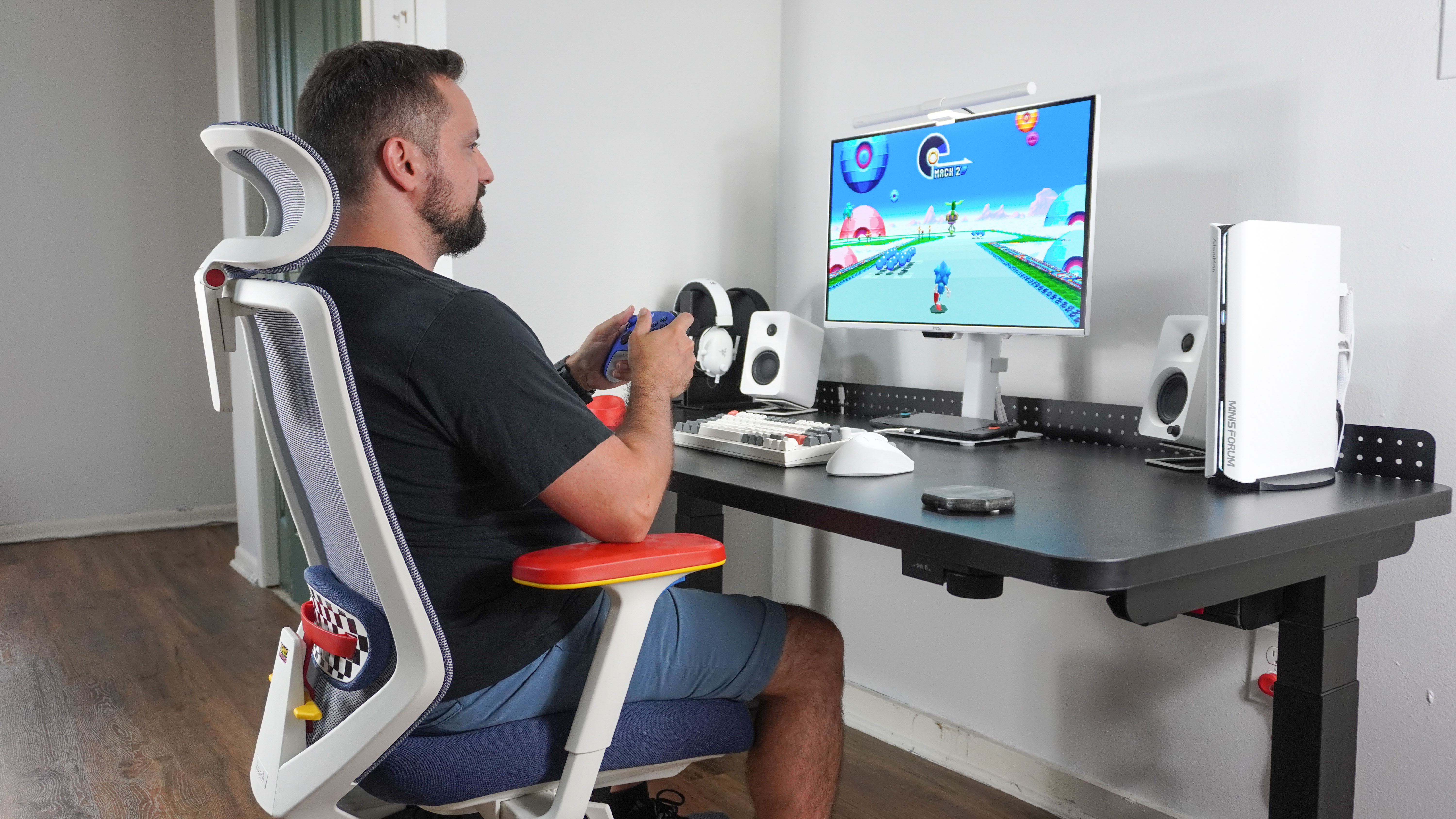 A person playing Sonic Mania while sitting in the Branch Ergonomic Chair Pro: Sonic the Hedgehog Edition