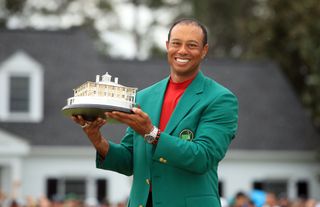Tiger Woods poses with 2019 Masters trophy whilst wearing the famous 'Green Jacket'