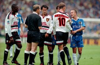 Chelsea's Dennis Wise pulls the shirt of Manchester United's Teddy Sheringham in the teams' Charity Shield clash in August 1997.