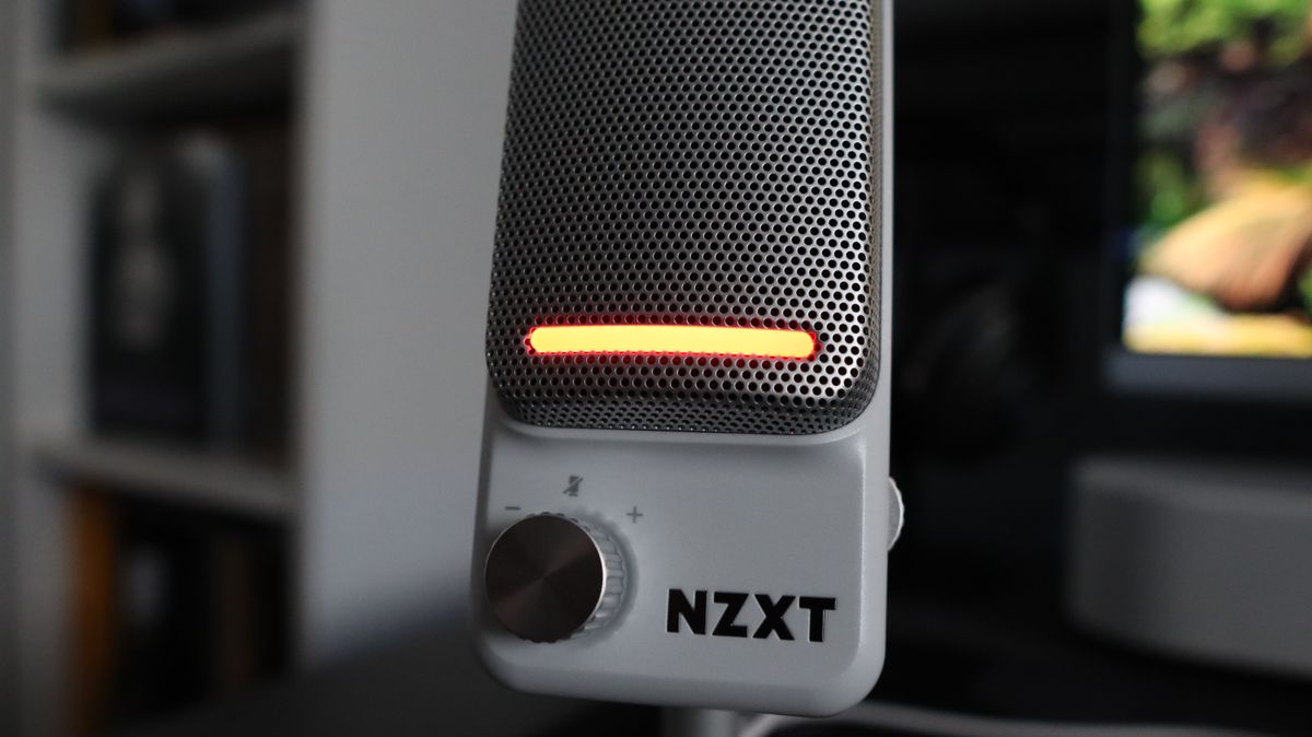 An NZXT Capsule Elite microphone set up on a desk with lighting enabled.