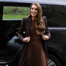 Princess Kate wears a brown satin dress.