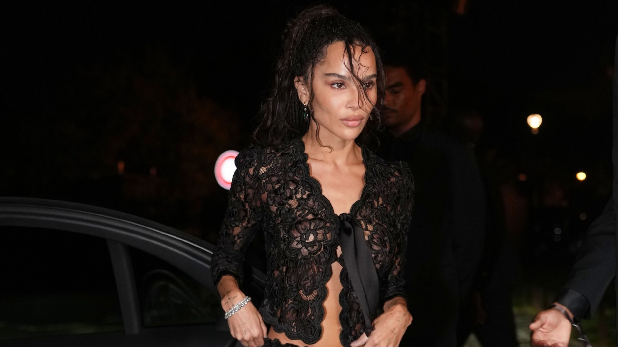 Zoe Kravitz wearing a sheer lace top. 