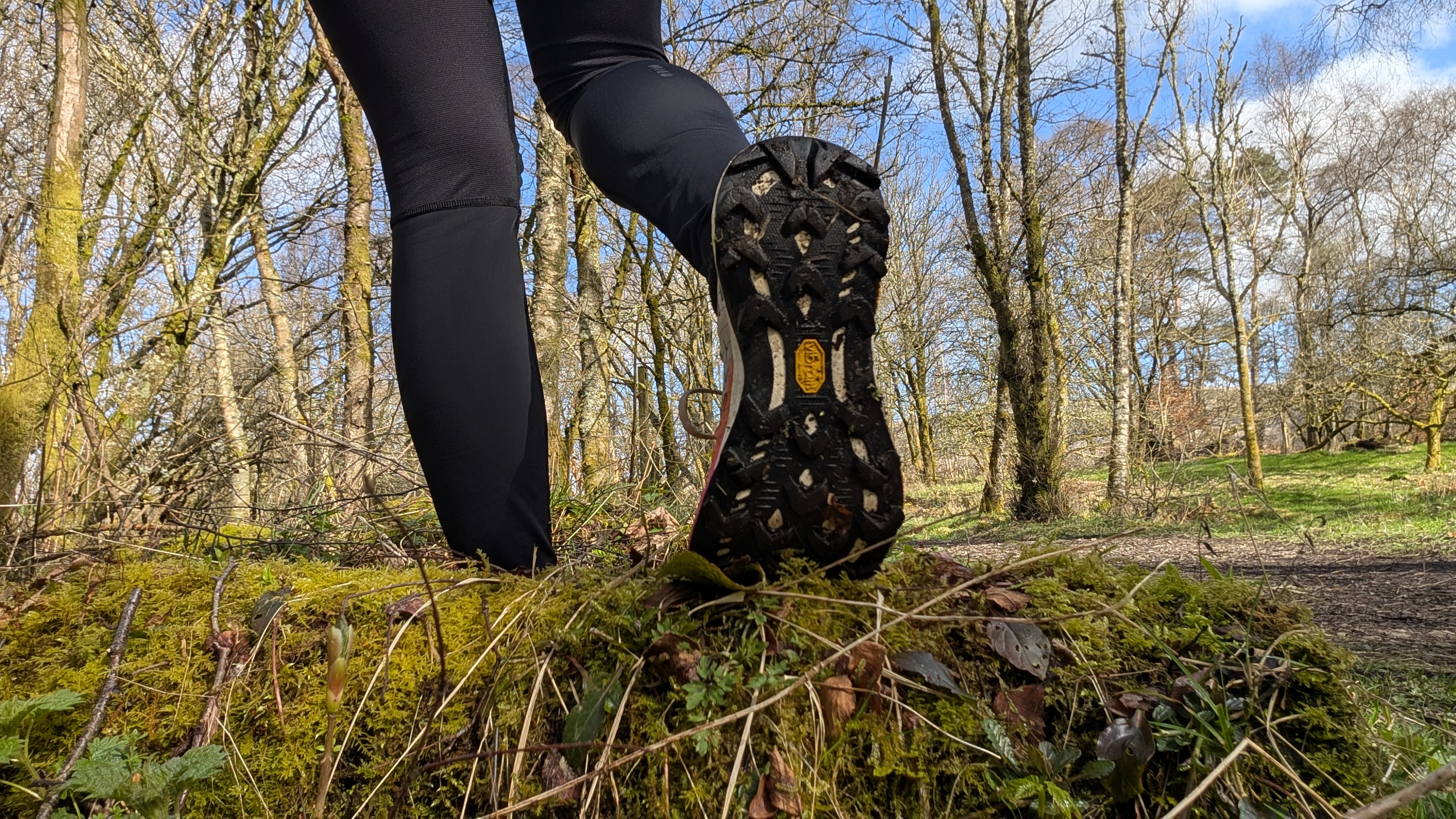 A runners feet showing the sole of the Merrell MTL Long Sky 2 trail running shoes
