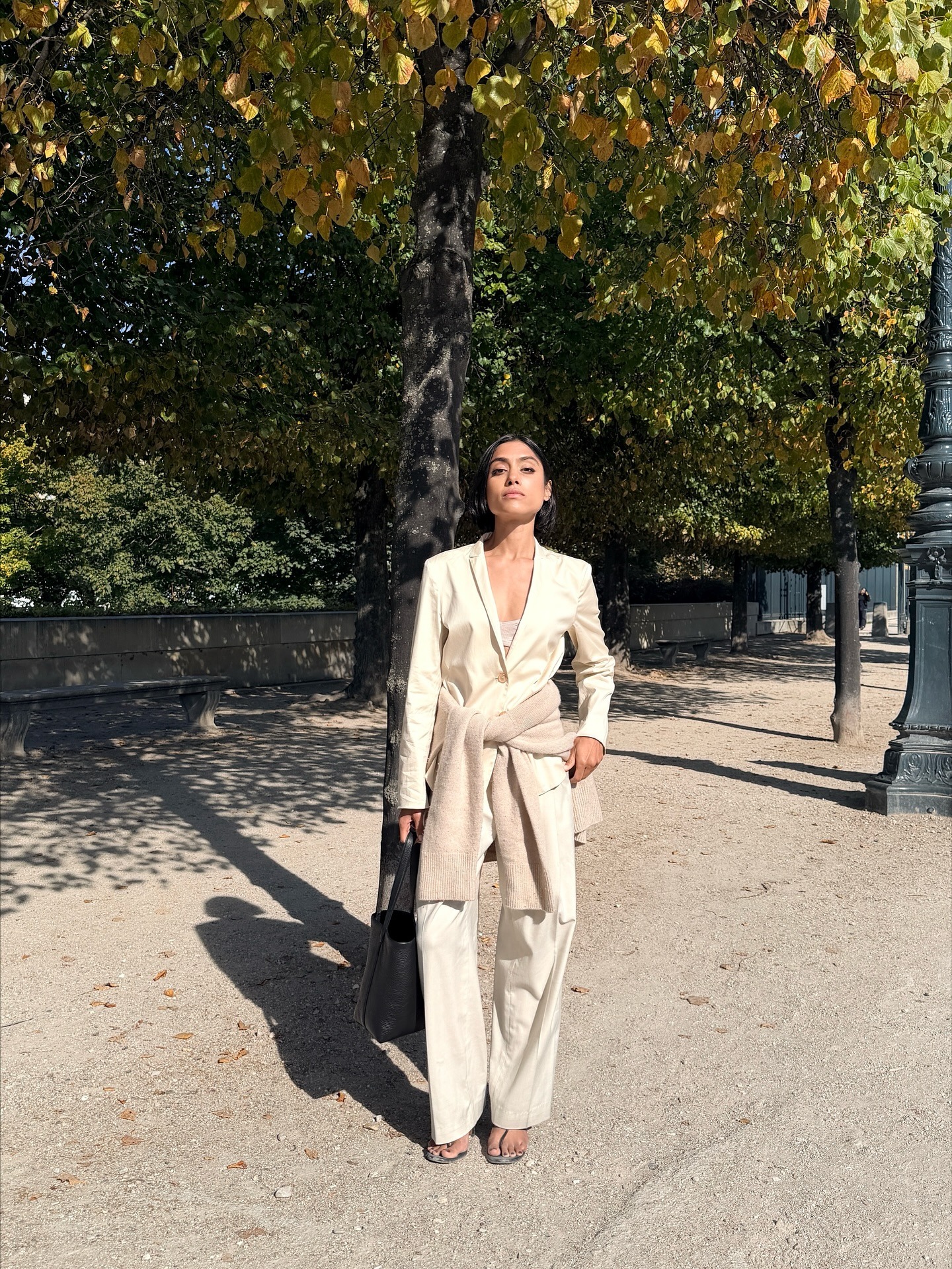 @shayinjune wearing a white suit and stretch thong sandals.