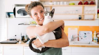 A person holding a cat