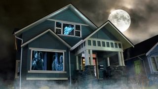 Halloween house exterior with scary images projected on window