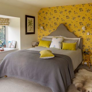 bedroom with yellow textured wall and white frame window