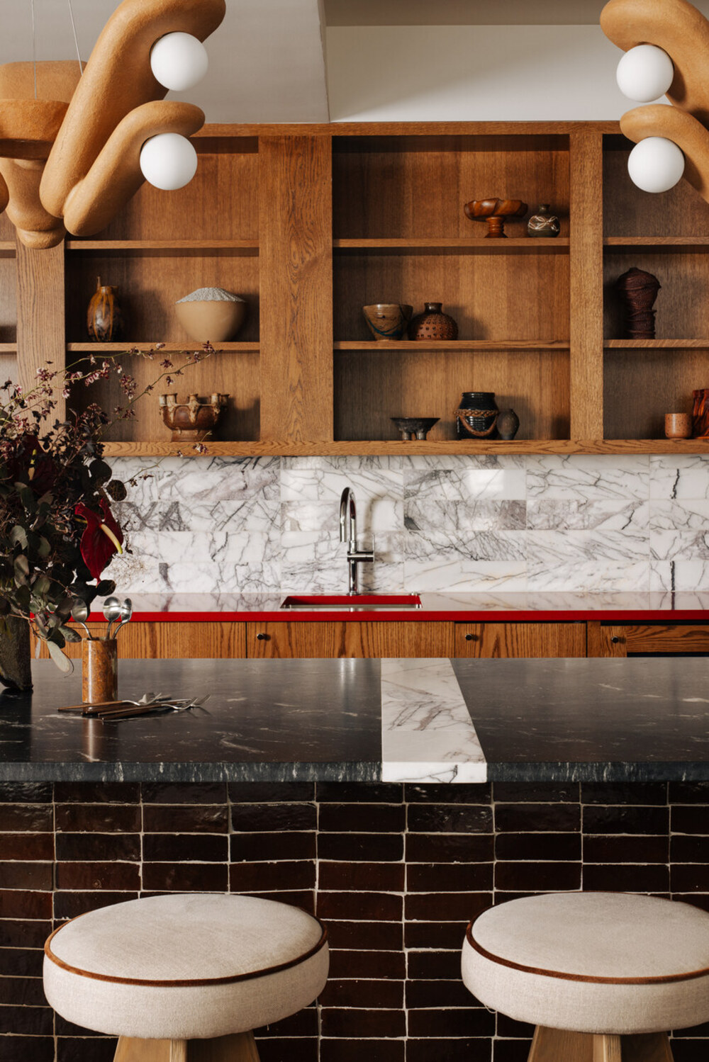 modern kitchen with tiled kitchen island, marble countertop, white marble backsplash, piped edge bar stools, timber upper cabinets