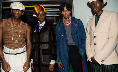 Male & female models pose for the camera in denim & knitwear