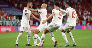 Hakim Ziyech (1st L) of Morocco celebrates scoring his side's first goal later ruled offside with their teammates during the FIFA World Cup Qatar 2022 Group F match between Belgium and Morocco at Al Thumama Stadium on November 27, 2022 in Doha, Qatar.