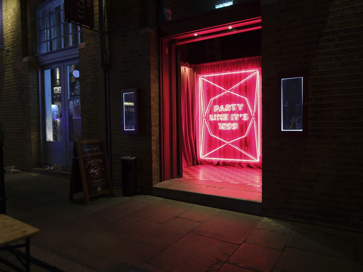 Fujifilm GFX100 RF sample images &ndash; entrance to a nightclub, red neon sign, at night